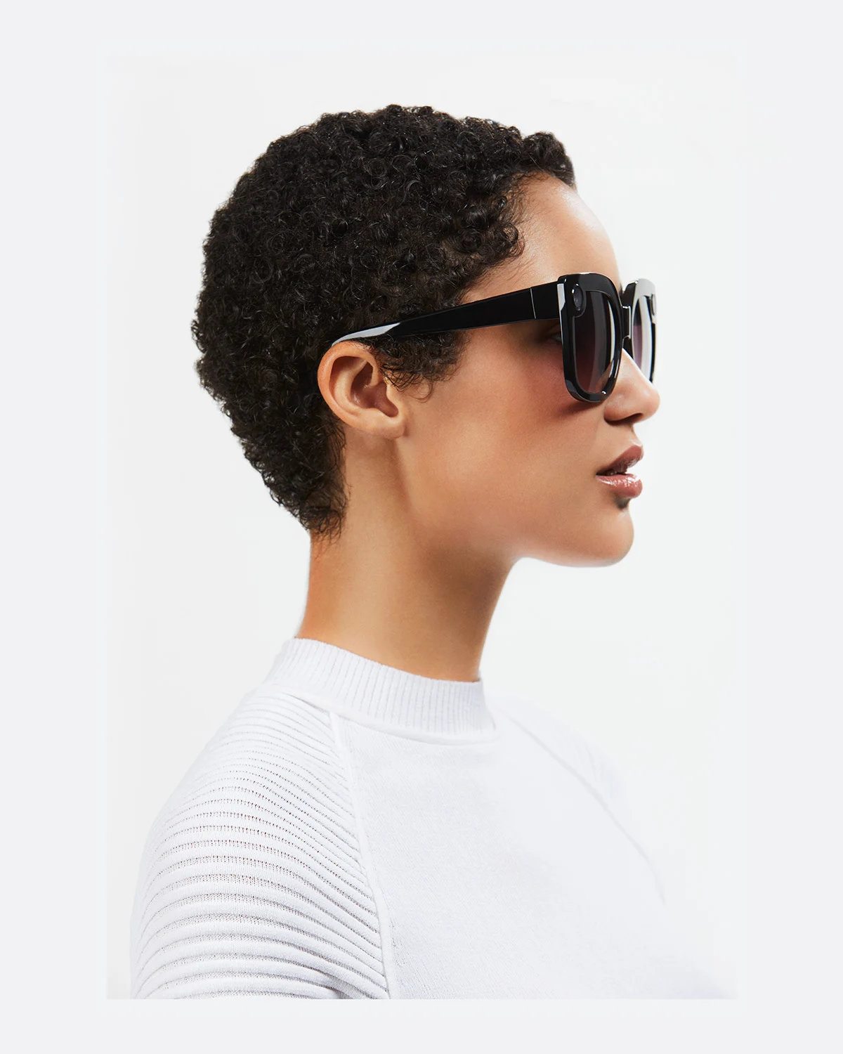Profile portrait showing the side of a black Spectacles frame.