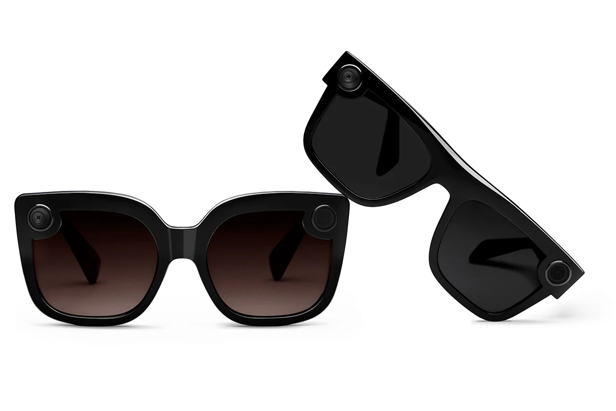 Two black Spectacles frames shown from different angles on white.