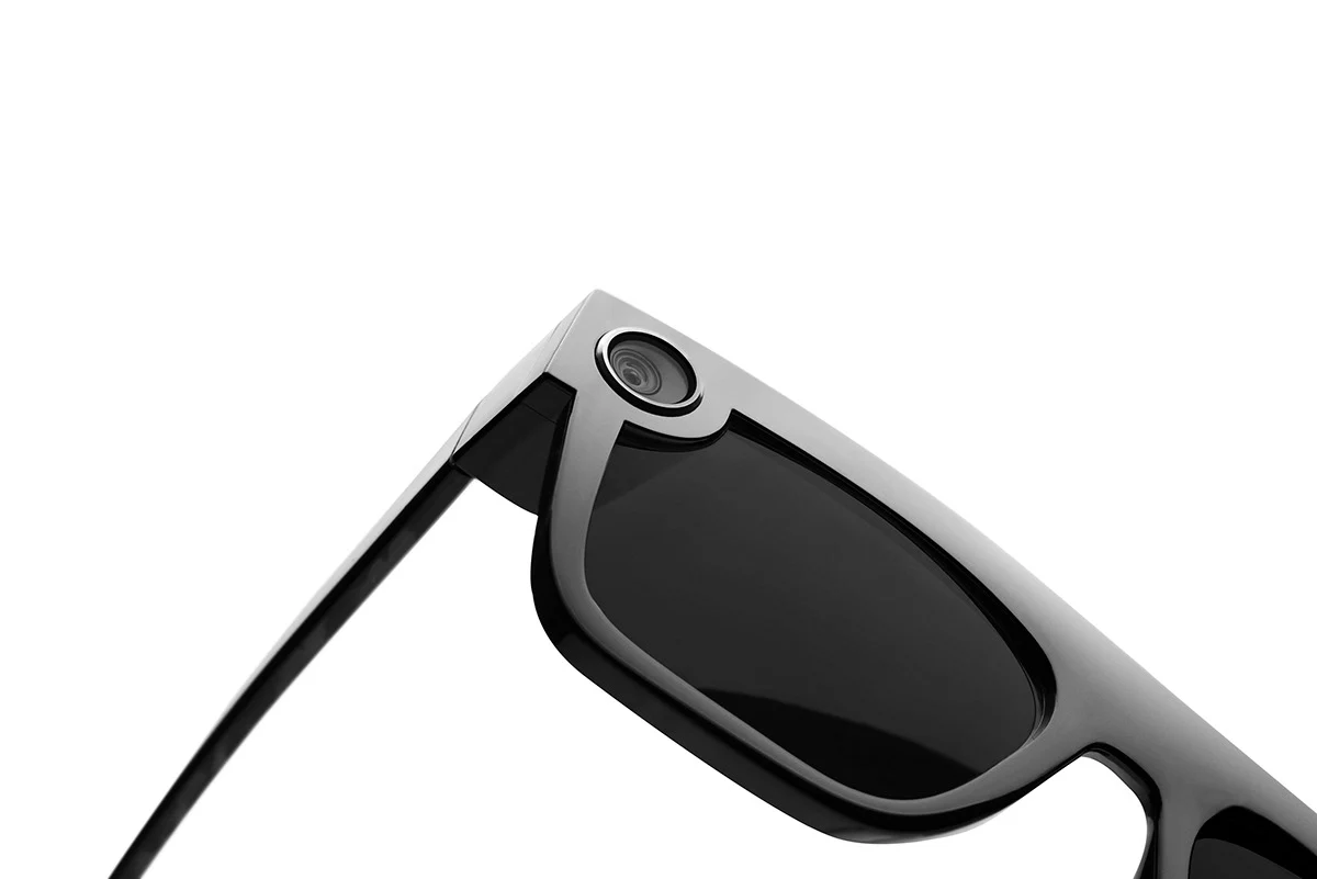 Close-up of the lens and camera detail on a black Spectacles frame.