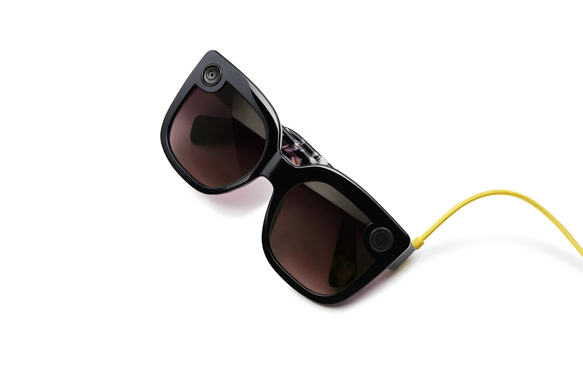 Spectacles with a yellow cable on a white background.