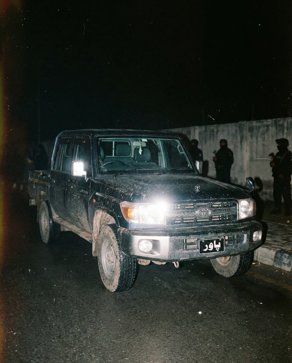 AI-generated image: A black off-road vehicle photographed with direct flash at night.