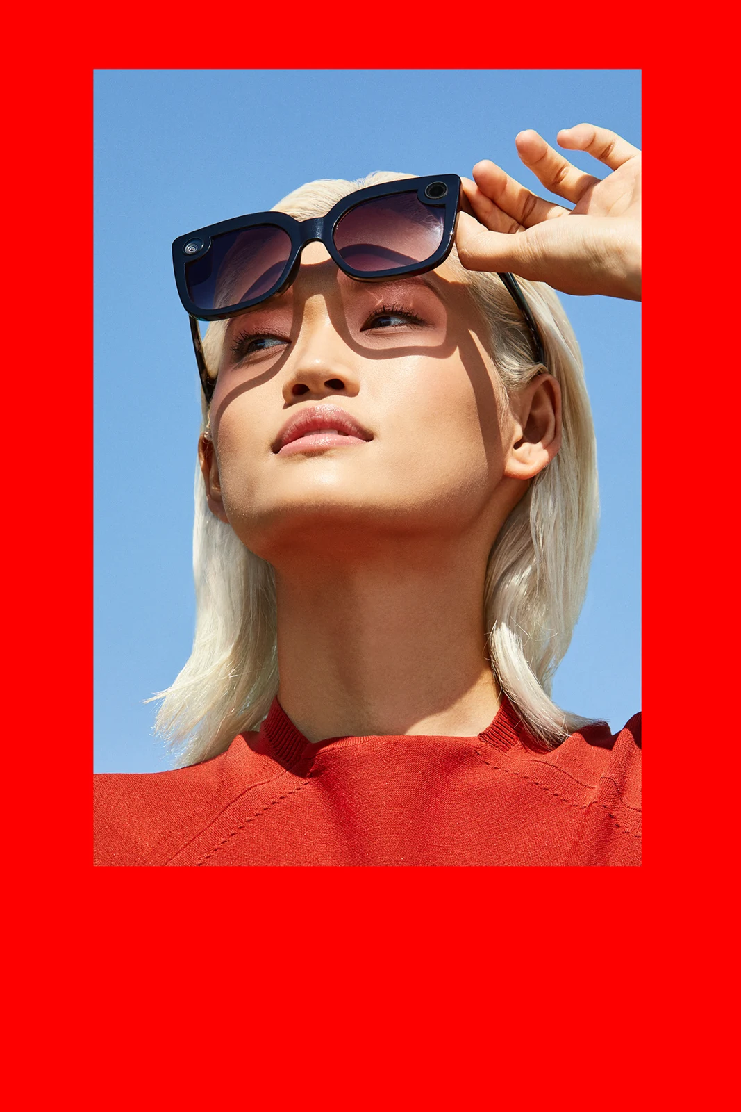 Portrait in red clothing and Spectacles within a red graphic border.