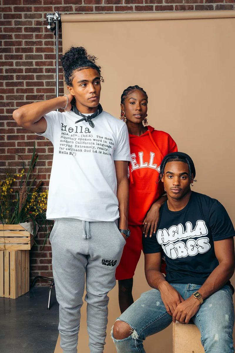 Three models wearing Hella Bay graphic tees.