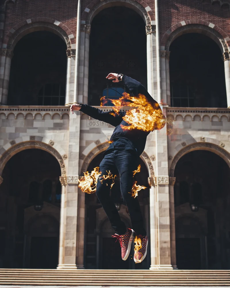 Filling Pieces fashion composite with a jumping model and flame effects.