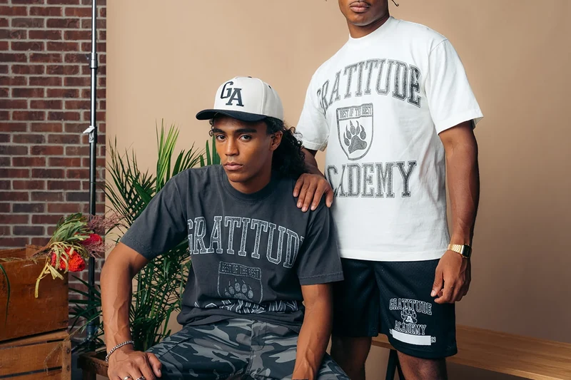 Close view of two Gratitude Academy outfits and a white basketball.