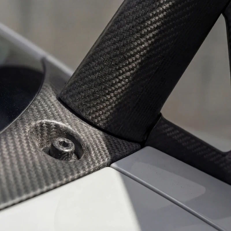 AI-generated detail of the carbon-fiber wing support and fastening.