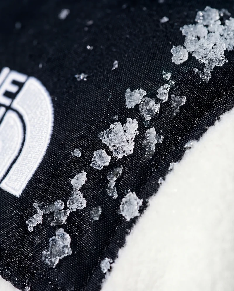 Close-up of snow crystals on The North Face jacket fabric.