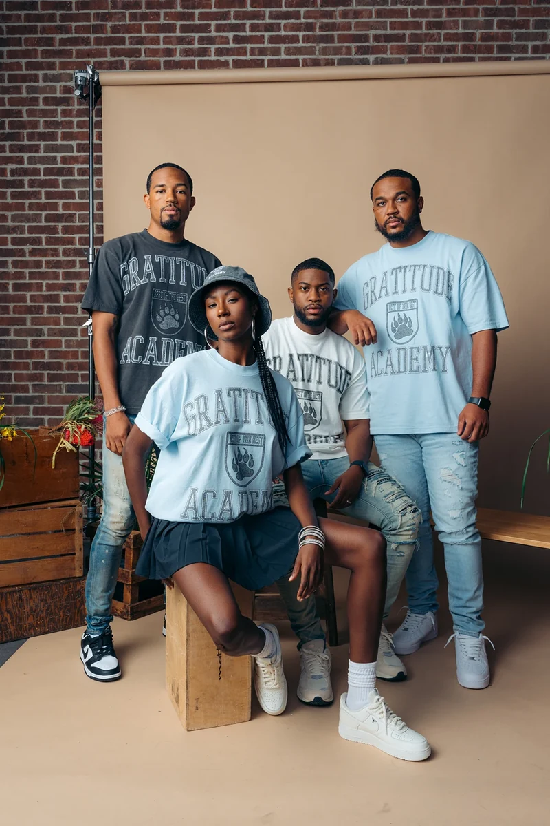 Group portrait of four models in Gratitude Academy clothing.