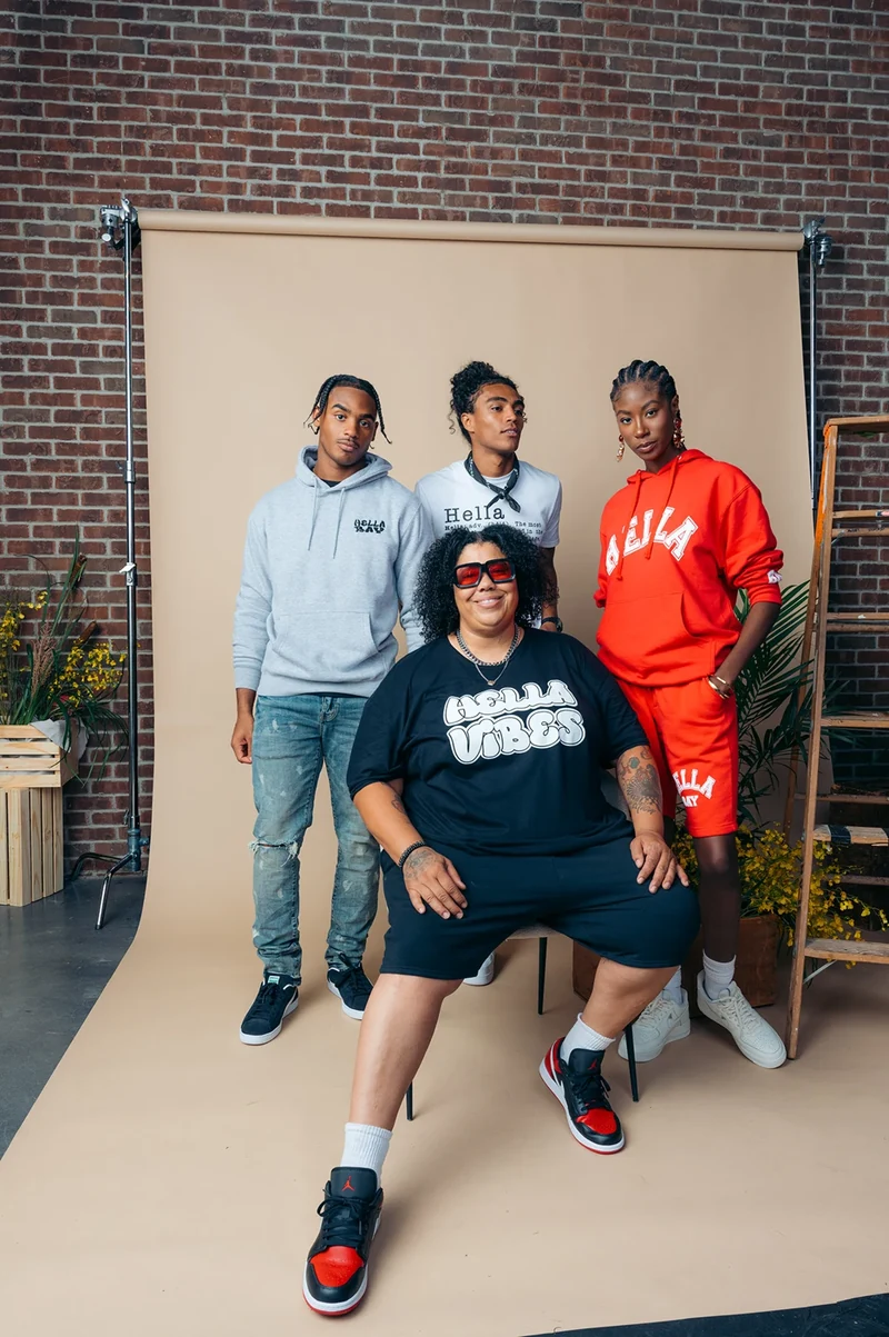 Four models posing in Hella Bay clothing on the studio set.