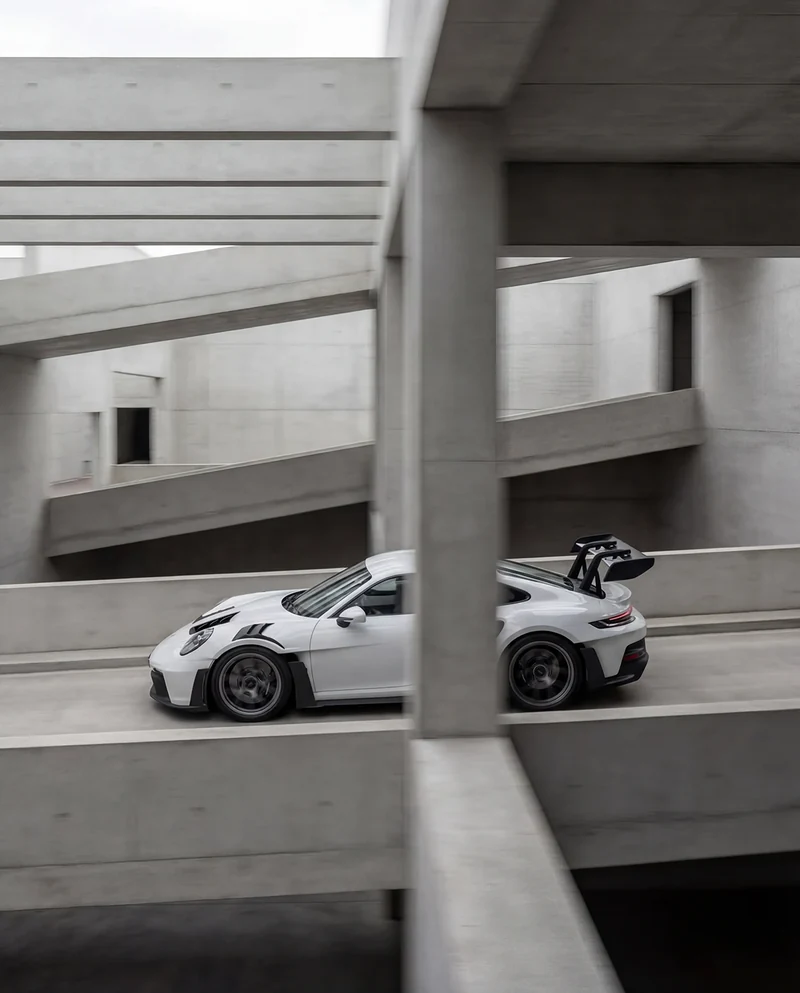AI-generated side view of the GT3 RS through concrete columns.