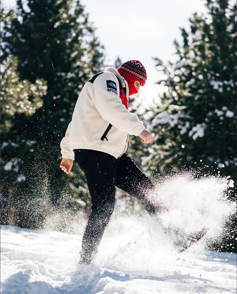 Model kicking up snow in the North Face jacket.