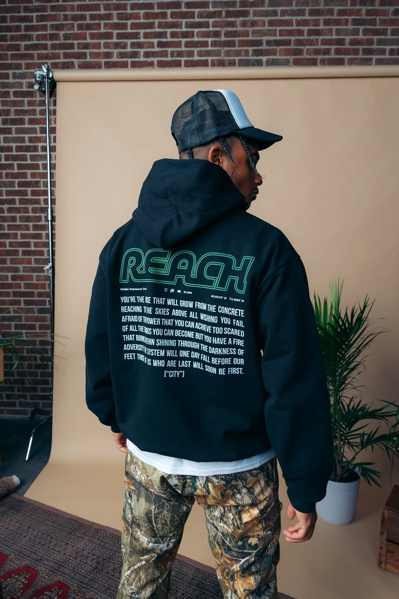 Rear view of a black hoodie with a large green back print.