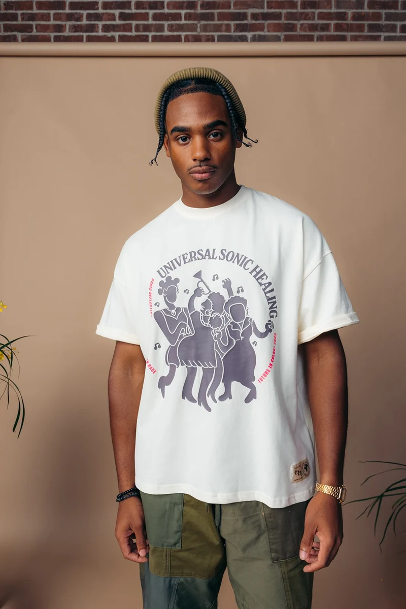 Model wearing a white Universal Sound graphic tee.