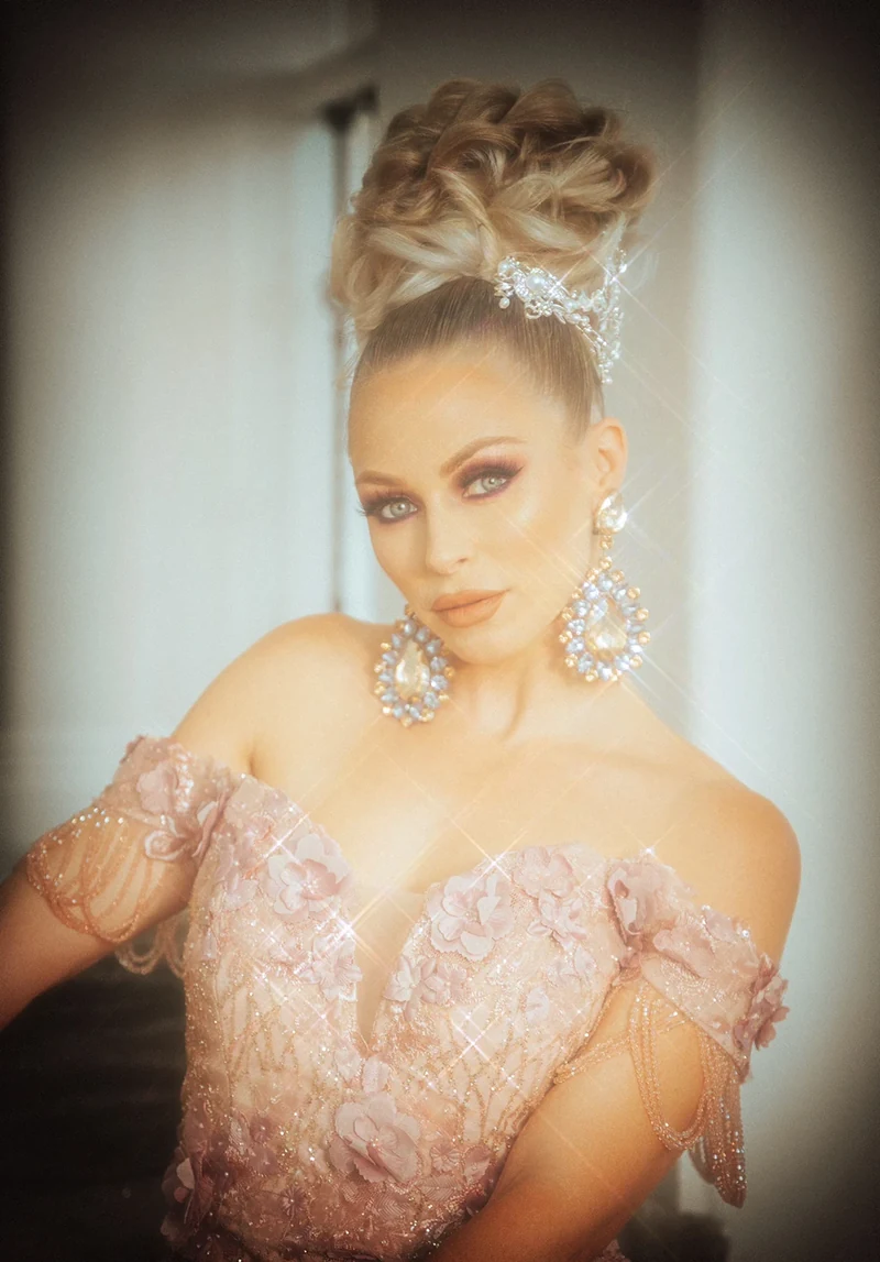 Soft-focus beauty portrait in a pink embellished dress.