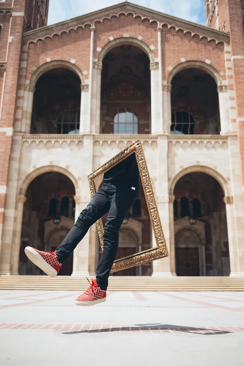 Filling Pieces fashion composite with a tilted frame against arched architecture.