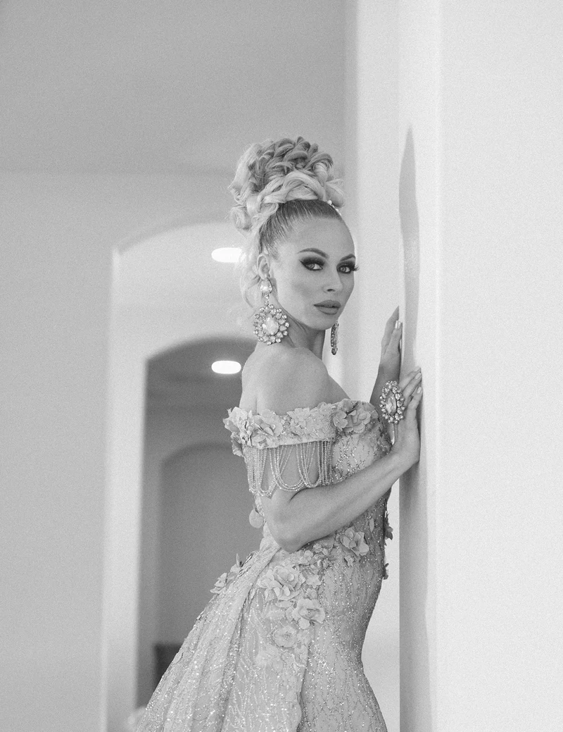 Monochrome portrait leaning against a doorway.