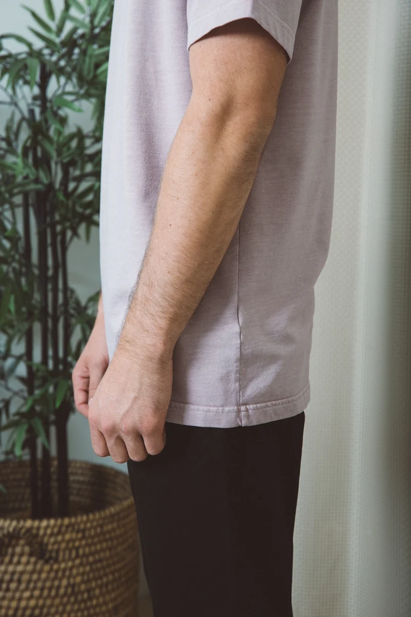 Close-up of a pale pink tee sleeve and hem.