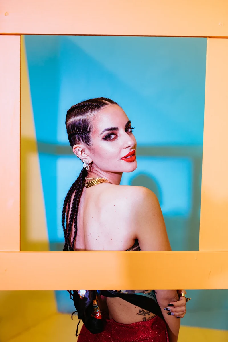 Portrait through a yellow frame against a blue background.