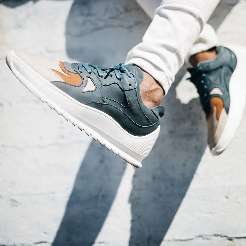 Close-up of gray and orange Filling Pieces sneakers.