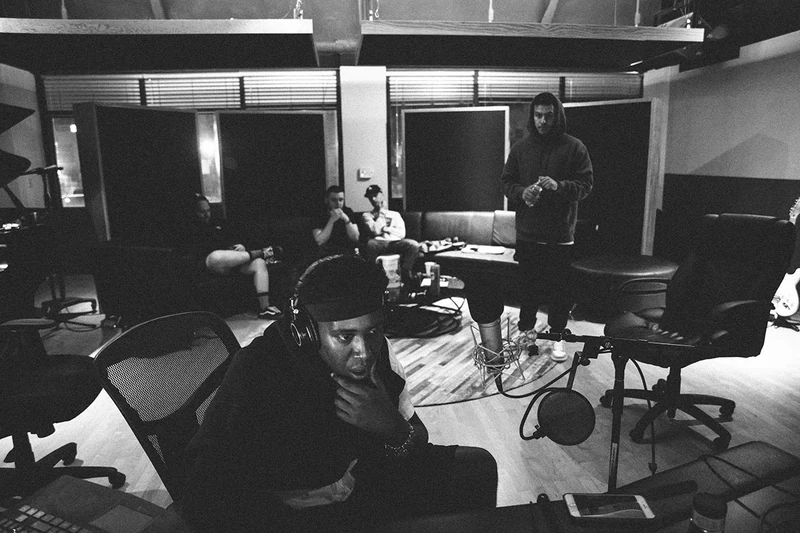 Wide monochrome view of 451 and collaborators in the studio.